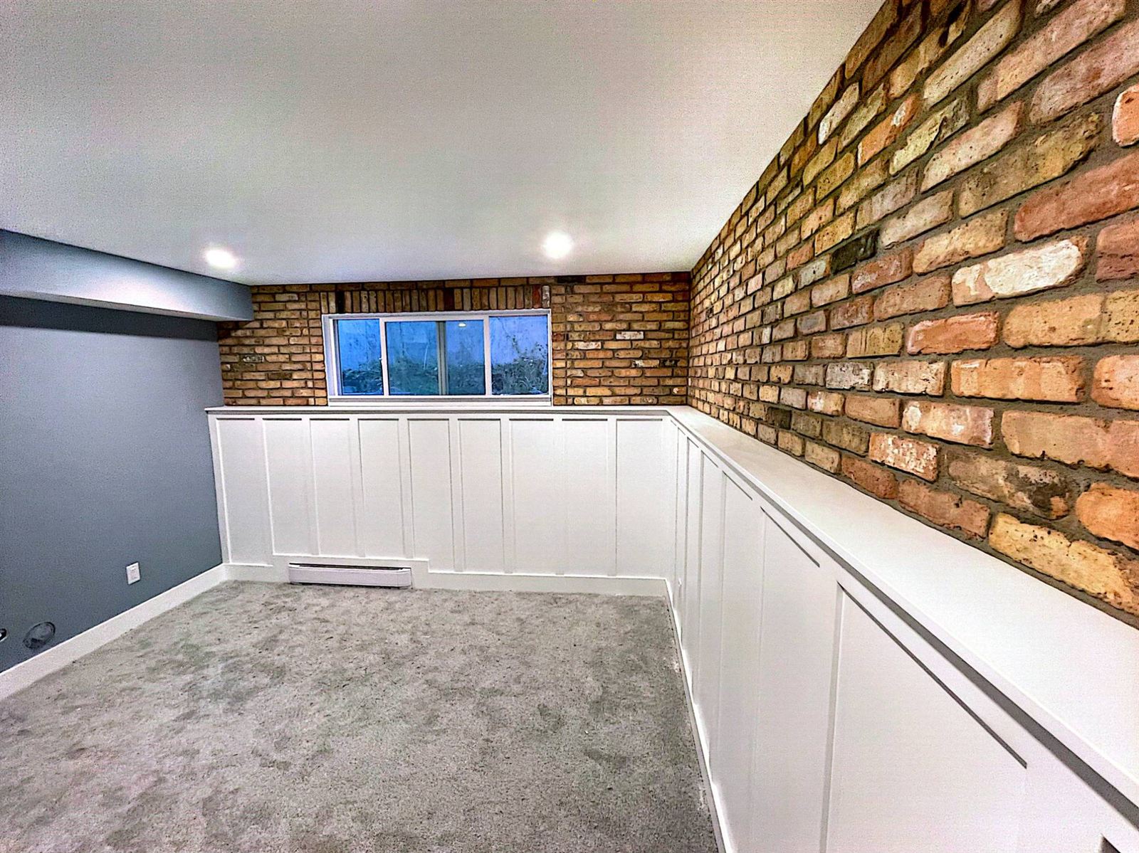 Basement development with brick wall and board-and-batten wainscoting