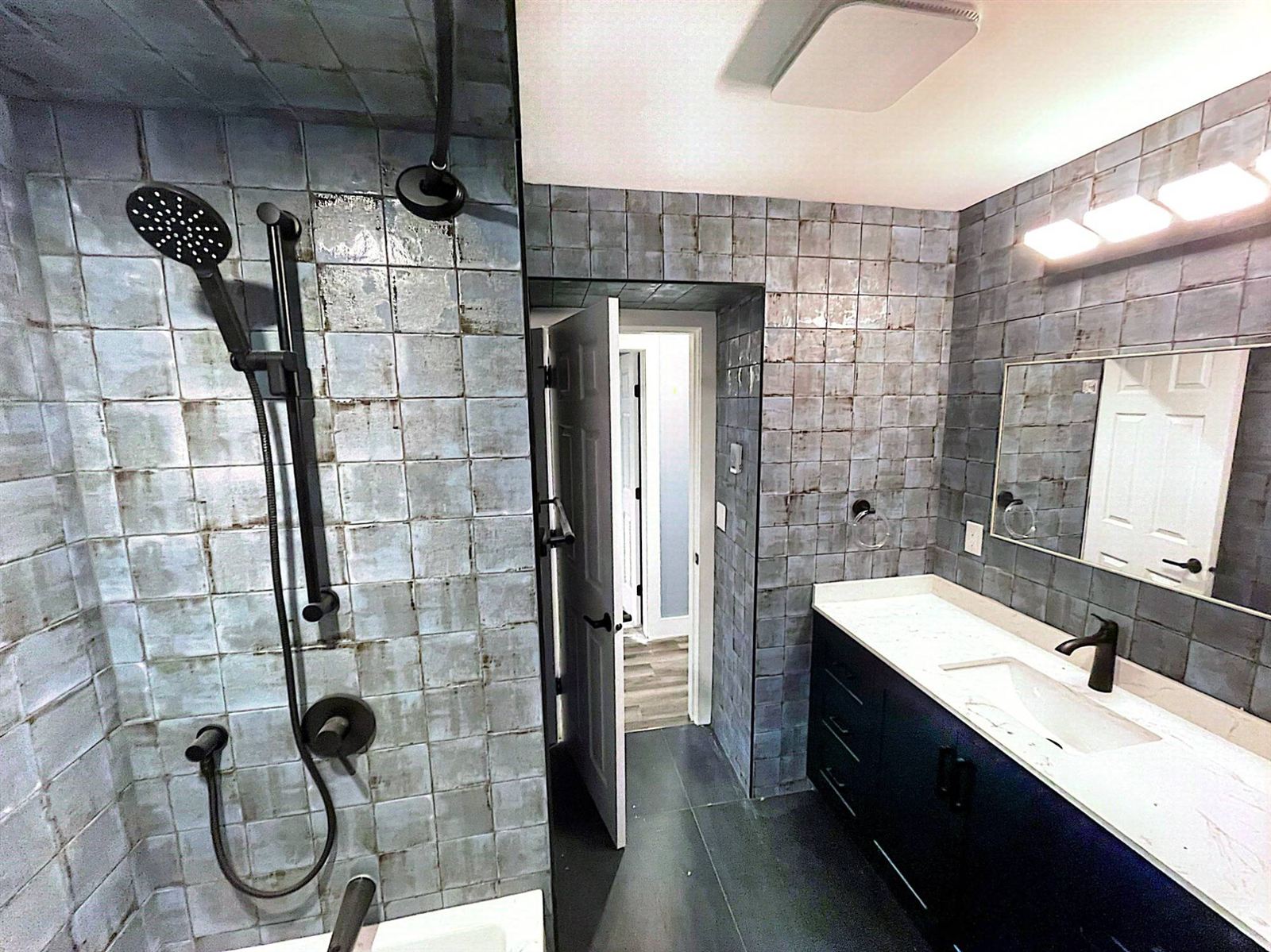 Bathroom renovation with handmade-look tile and navy vanity