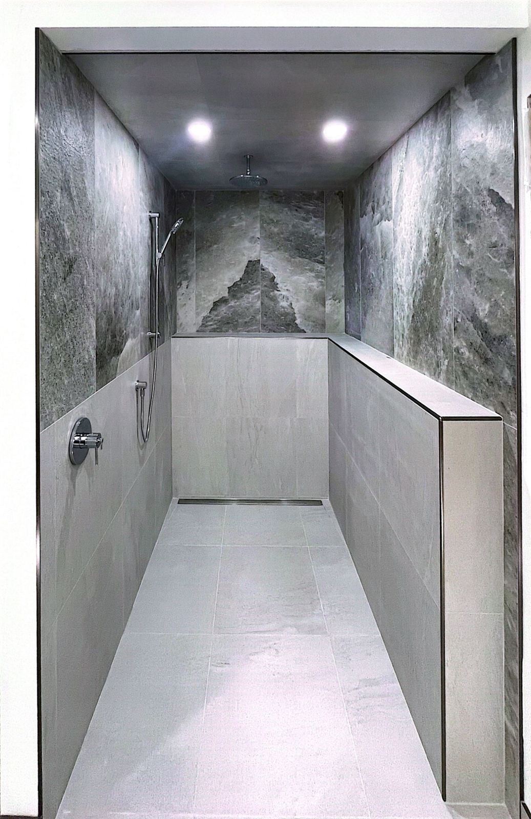 Curbless walk-in shower with large-format tile