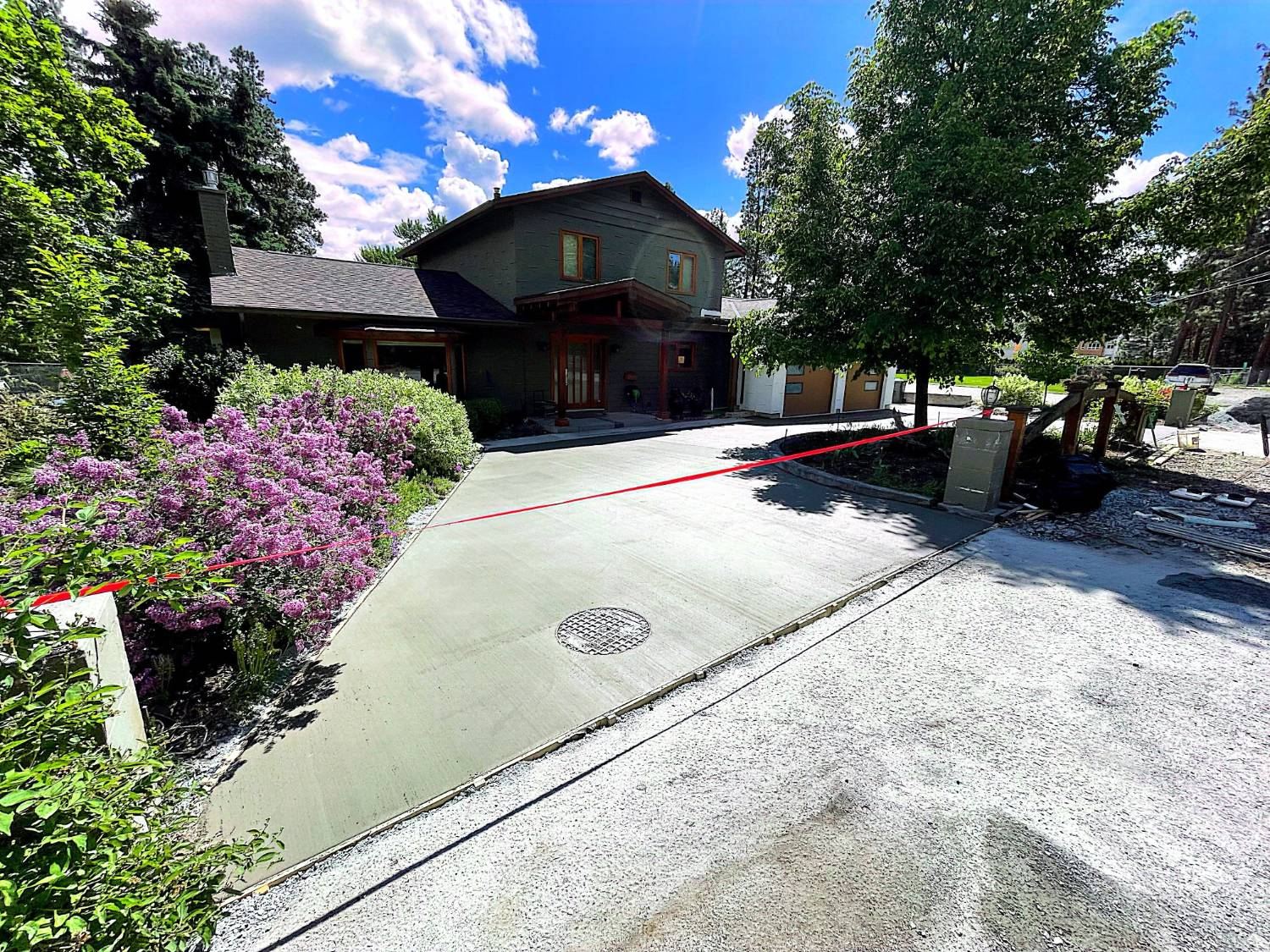After: freshly poured concrete driveway