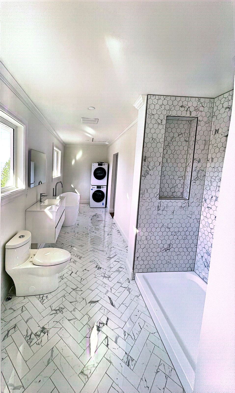 Ensuite renovation with herringbone marble tile