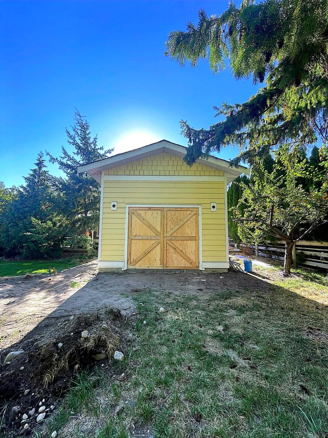 Custom backyard outbuilding with barn doors