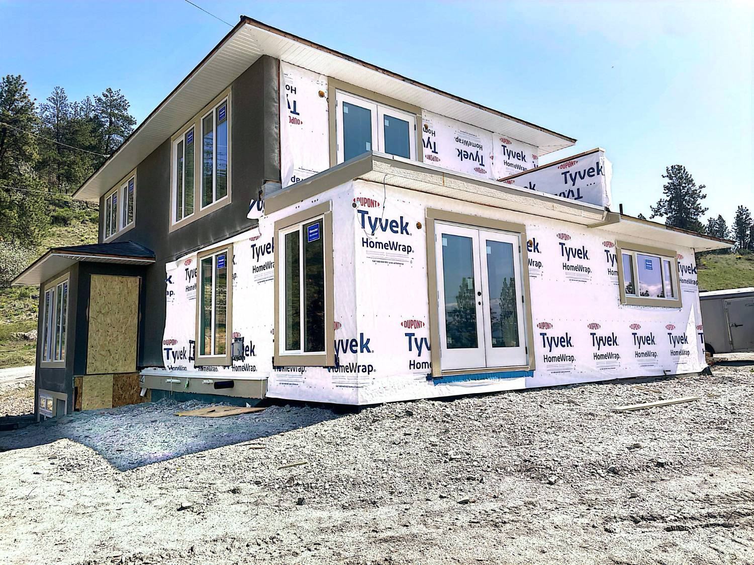 Addition wrapped with windows and doors installed